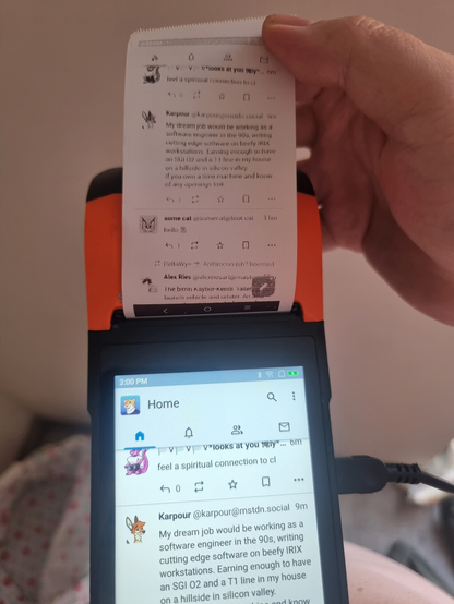 A POS device running tusky mastodon client, the same image on screen is printed 
